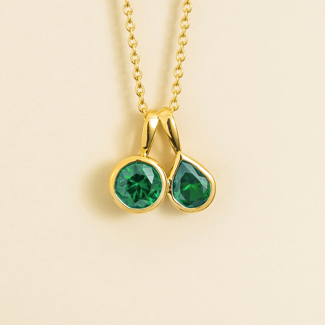 Prunus gold necklace set with Emerald