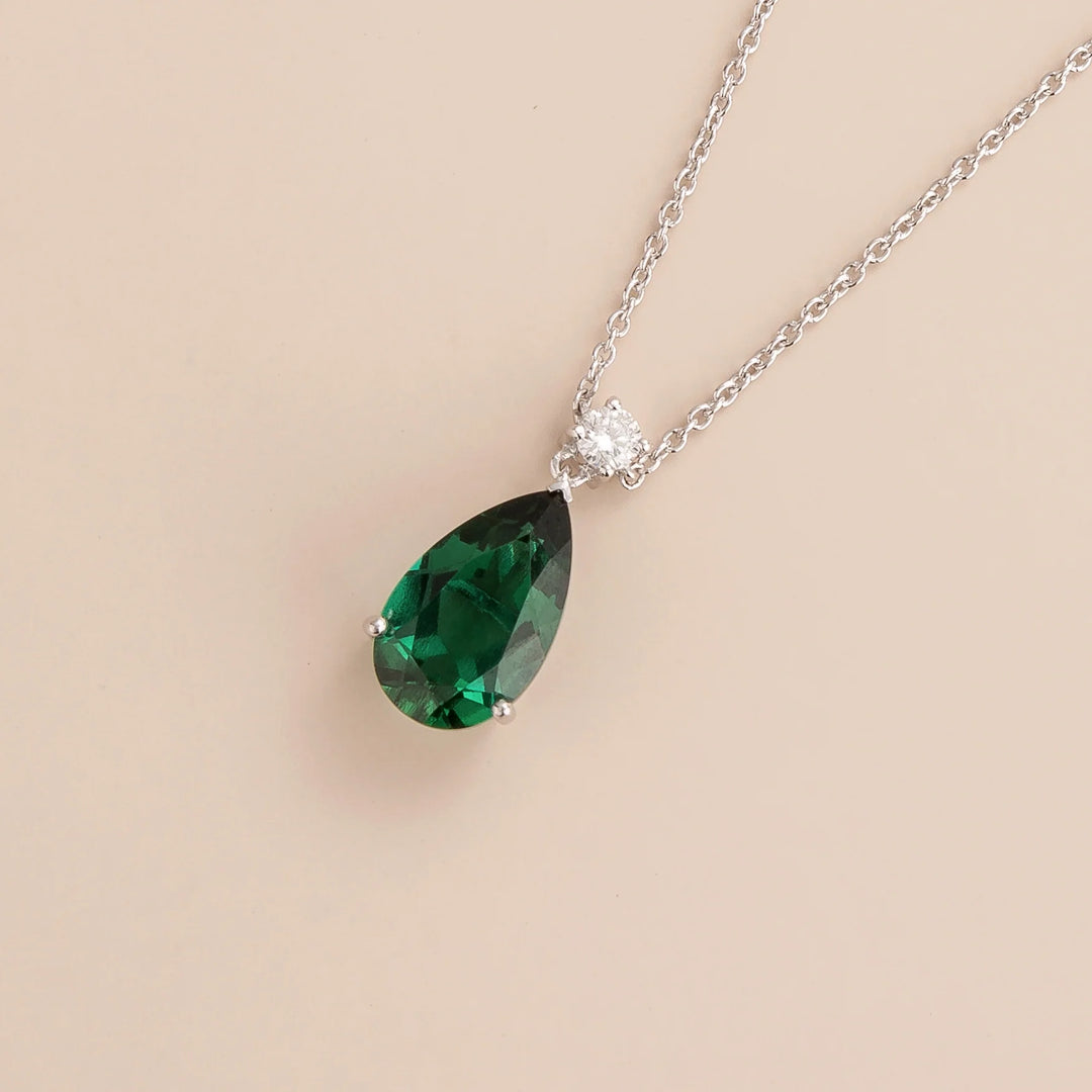 Ori pear drop necklace in 18K white gold vermeil set with lab grown emerald and diamond gem stones.