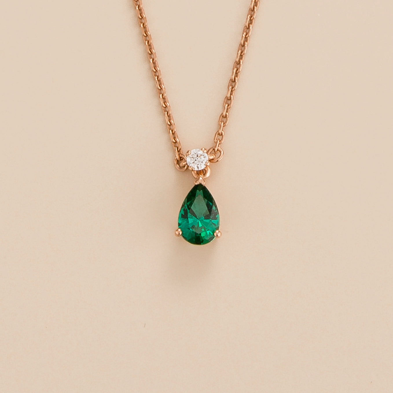 Ori pear drop necklace in 18K pink gold vermeil set with lab grown emerald and diamond gem stones.